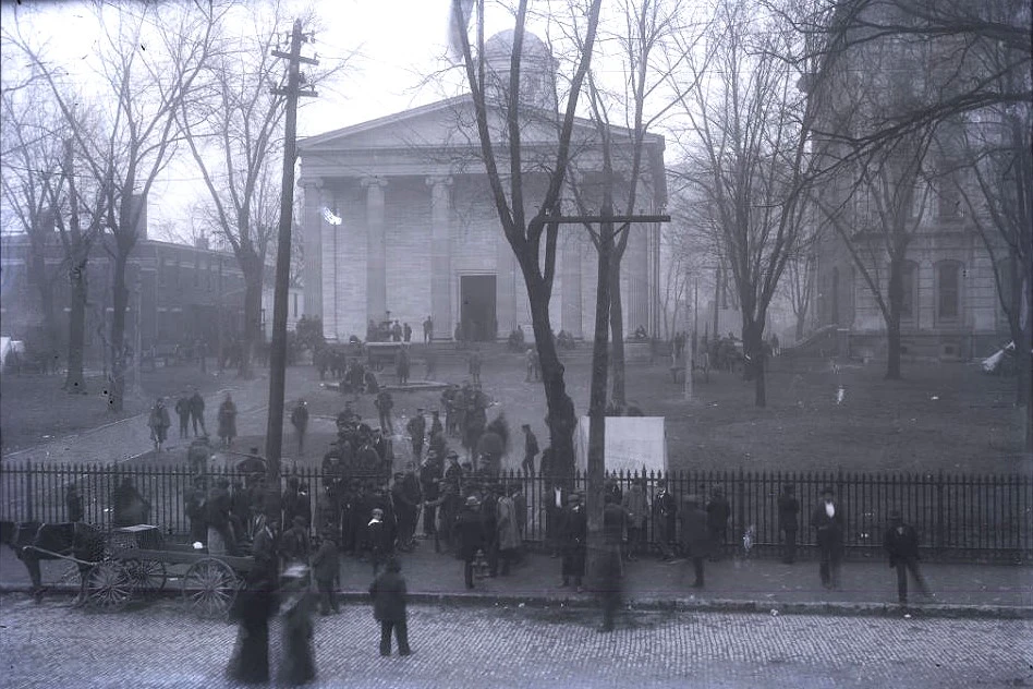 Black and White photograph of the grounds of Kentucky's Old State Capitol with a crowd of people following the assassination of Governor Goebel.